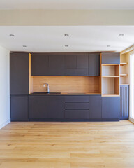 Modern minimalist kitchen interior with wooden floor and natural light