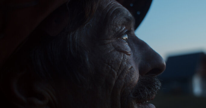 Close up of an elderly man's face at dusk