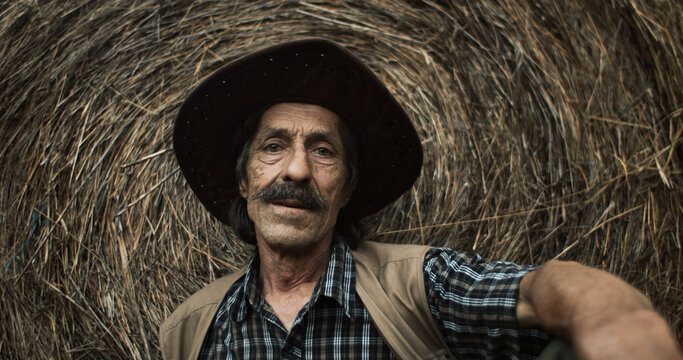 Villager rests next to a hay bale
