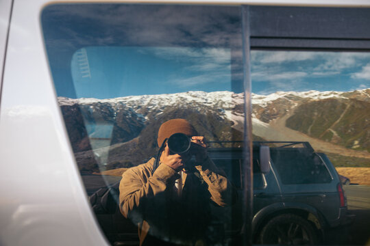 Reflection on a car window of a photographer in New Zealand