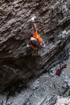 Rock Climber Reaching for Hold