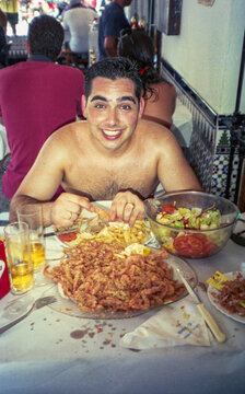 eating prawns shirtless