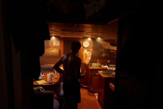 Man standing in the cabin of a boat