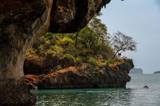 Limestone cave overhang and rocky coastline at Phra Nang Beach in Railay Krabi