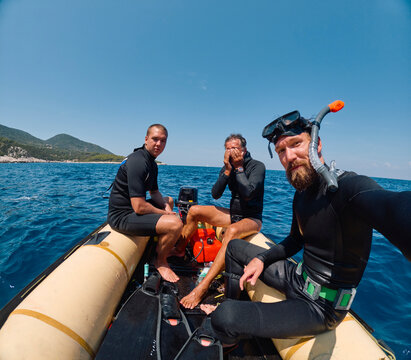 Divers take a selfie on a boat