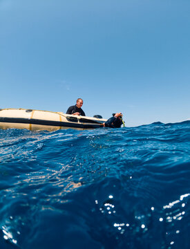 Diver is holding on to the boat