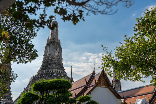 Vibrant orange and green tiled roof with golden Chofa finials at Wat Arun, Bangkok