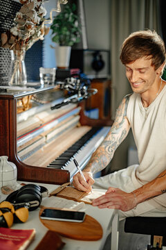 A cheerful musician writes music