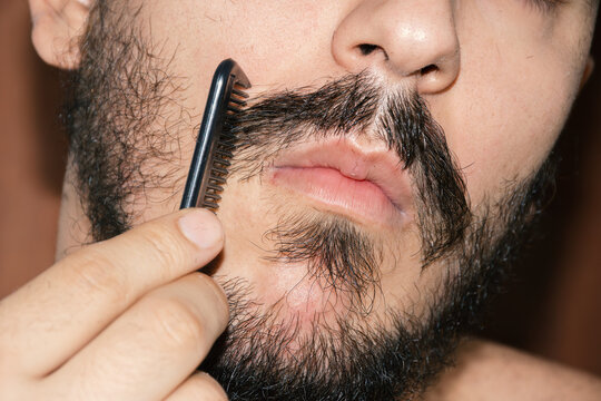 Man combing his mustache