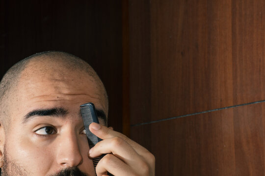 Man combing his eyebrows