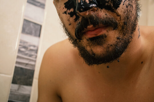 Man washing off face mask 