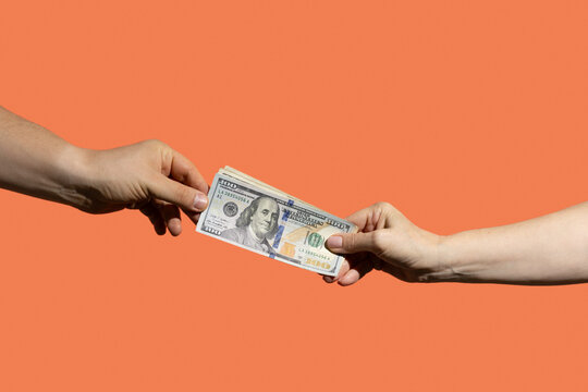 Two people passing money