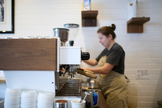 Barista Preparing Coffee During Morning Rush at Local Cafe