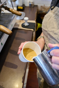 Barista Pouring Espresso Into Cup at Caf&eacute;