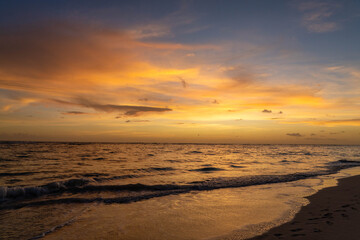 Obraz premium Sunrise with Orange Sky Over the Caribbean Sea in Punta Can Dominican Republic
