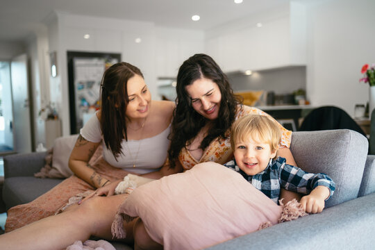 Toddler with his mothers at home