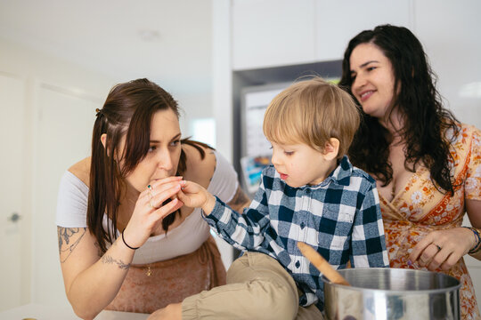LGBT family baking a cake at home