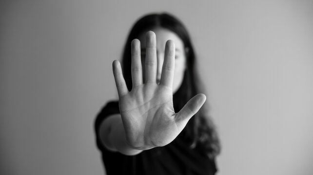 Close-up Black and White of Woman's Hand Signaling Stop