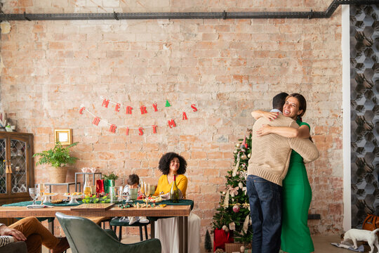 People hug after Christmas gift exchange time
