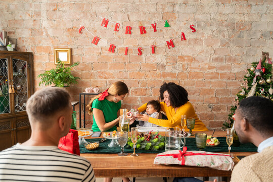 Gift giving moment at Christmas dinner indoors