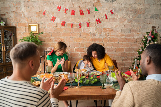 Cheerful family meeting in home at Christmas time