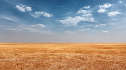 Obraz premium Vast Arid Landscape Under Clear Blue Sky with Wispy White Clouds and Dry Brown Earth Highlighting Beauty of Nature's Desolation