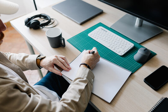 A freelancer starting his work routine writing down his to-do list