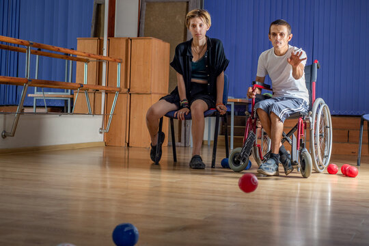 Young guy with a disability training with his coach.
