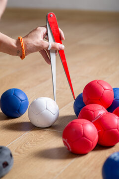 Anonymous person measures the distance between balls in a game