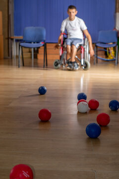 Anonymous Young disabled palayer plays boccia in wheelchair