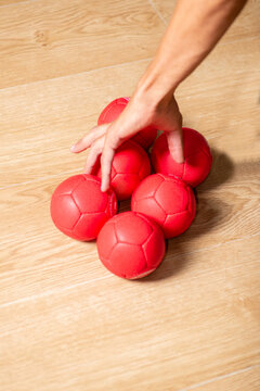 Balls for playing boccia and a hand of an athlete with cerebral palsy