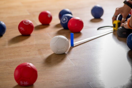 Anonymous person measures the distance between balls in a game