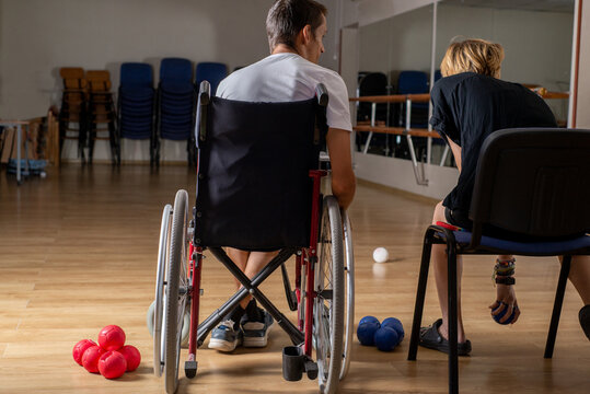 Anonymous Young disabled paralympic athlete with his trainer
