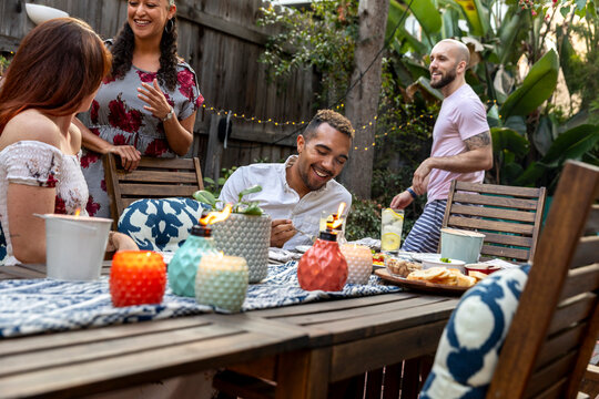 Laughter and Appetizers Among Friends in a Cozy Backyard Setting