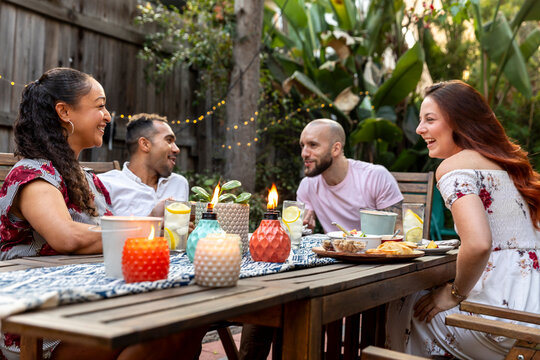 Friends Enjoying a Delicious Meal and Conversation in a Cozy Bac