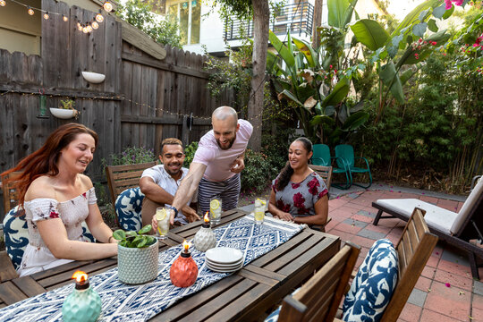 Friends Enjoying Refreshing Lemonade in a Charming Backyard Sett