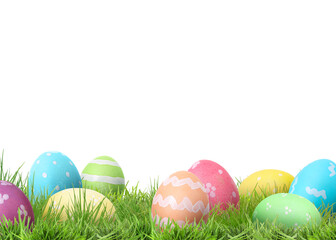 Fototapeta premium Easter eggs in green grass against white background