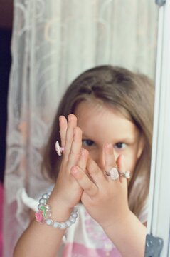 The girl is showing off her jewelry .