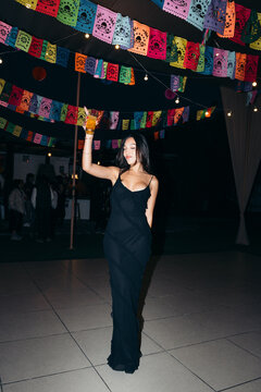 Woman dancing while holding a drink in a party