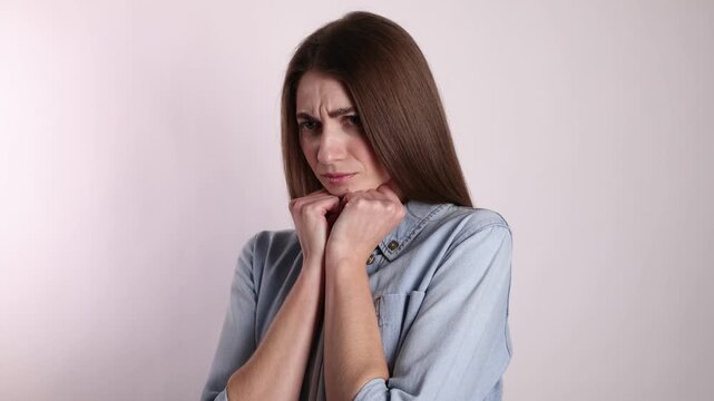 Portrait of resentful woman on light grey background