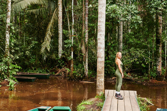 Blonde woman exploring rainforest