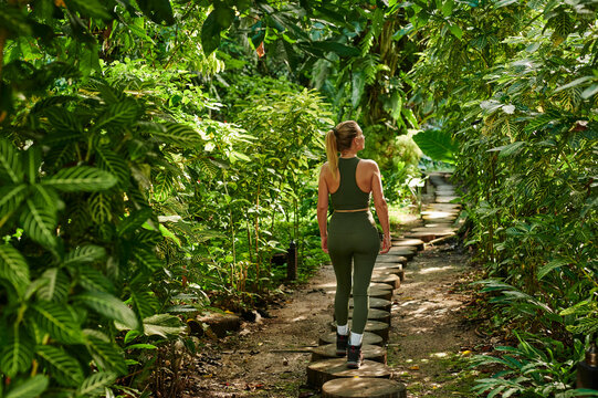 Blonde woman exploring rainforest
