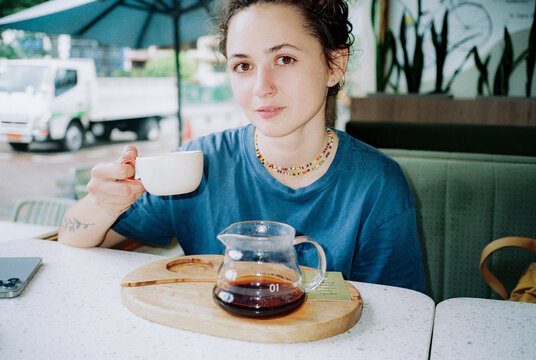 Portrait of woman drinking coffee in cafe during trip to Ecuador 