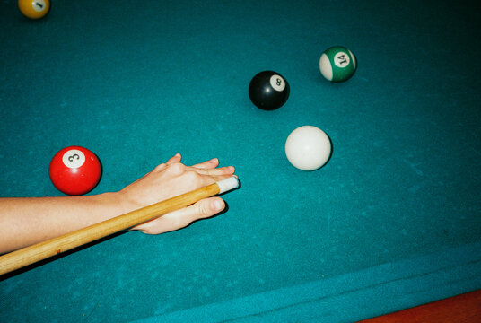 Woman playing pool, shot on film with flash 