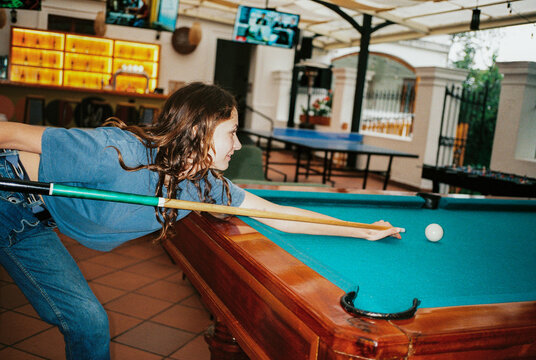 Woman playing pool, shot on film with flash 