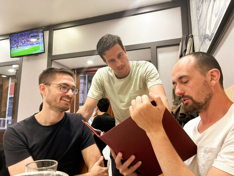 UGC friends looking at menu in portuguese restaurant
