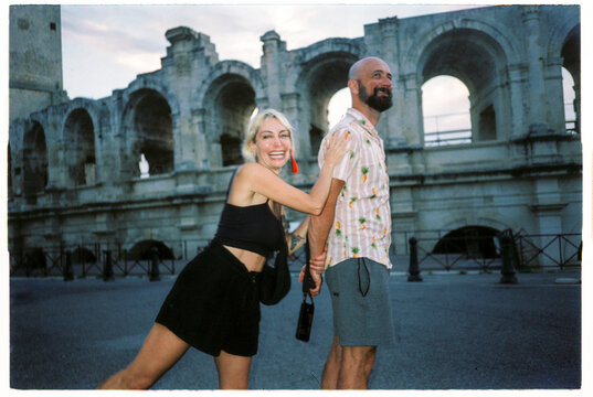 Joyful couple visiting ancient coliseum 