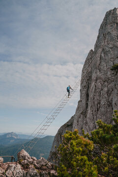 Man climbing sky ladder via ferrata in Austria 