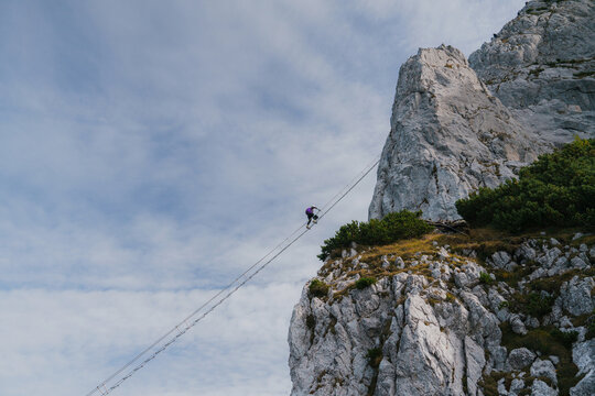 Man climbing sky ladder via ferrata in Austria 