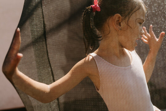 Playful Kid jumping on the trampoline